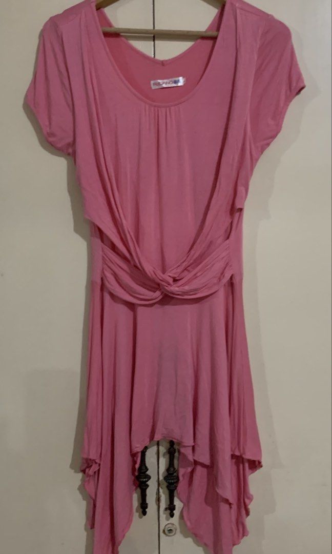 Pink Twisted Drape Asymmetrical Hem Dress (Category: Dresses) located in Paranaque City. Submitted by vbvessentials (Listing ID 1447998965, Image 1). Description: - Pink FUDANG dress - Flattering twisted drape detail at the waist - Unique asymmetrical hemline - Comfortable short sleeves - Soft and flowy fabric - Versatile for casual outings or dressing up - Measurements: Waist approx. 15 inches (laid flat), Length approx. 32 inches (shortest poin
