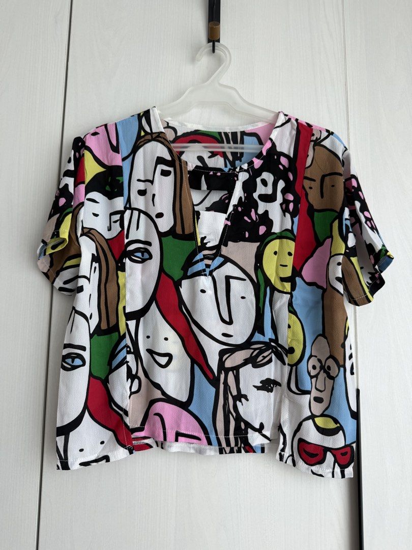 Printed V-Neck Top with Cut-out Detail (Category: Blouses) located in Manila. Submitted by qfclutz (Listing ID 1447983301, Image 2). Description: - Unique V-neck with cut-out detail with abstract face print - Lightweight fabric - Easily pairs with pants or skirts.