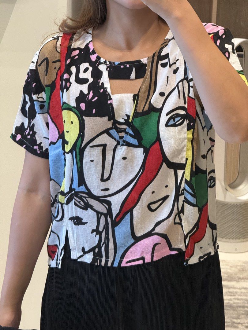 Printed V-Neck Top with Cut-out Detail (Category: Blouses) located in Manila. Submitted by qfclutz (Listing ID 1447983301, Image 1). Description: - Unique V-neck with cut-out detail with abstract face print - Lightweight fabric - Easily pairs with pants or skirts.