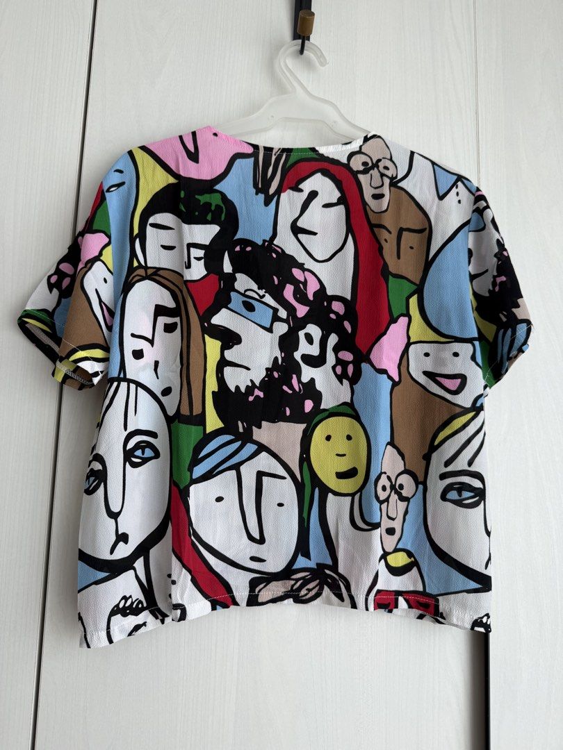 Printed V-Neck Top with Cut-out Detail (Category: Blouses) located in Manila. Submitted by qfclutz (Listing ID 1447983301, Image 3). Description: - Unique V-neck with cut-out detail with abstract face print - Lightweight fabric - Easily pairs with pants or skirts.