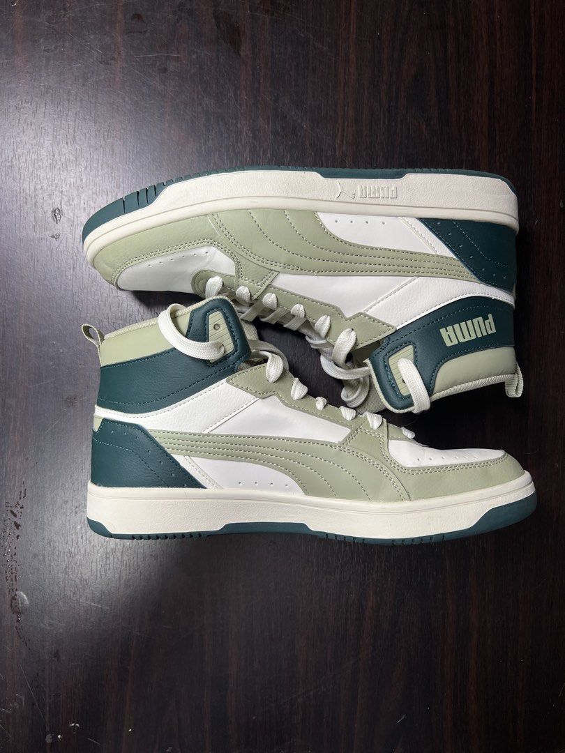 Puma High Top Sneakers - White/Green (Category: Sneakers) located in Marikina City. Submitted by lorenzothrifted (Listing ID 1447924916, Image 3). Description: - Puma high top sneakers (Used Once) - US 10.5 - Color: White with sage green and dark green accents - Style: Classic lace-up - Perfect for casual wear - Please check photos for detailed condition.