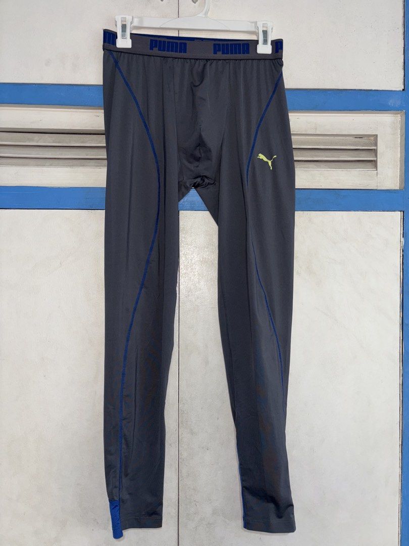 Puma Men's Grey Athletic Tights Size S (Category: Activewear) located in Pasig City. Submitted by timmybatoon (Listing ID 1448076795, Image 1). Description: Puma Compression Tights (GRAY) Size on tag: S (MENS) Dimensions: 27-32inW x 36inL Price: 800 - Grey Puma athletic tights - Blue accents on sides and ankles - Puma logo on left leg - Elastic waistband with Puma branding - Made in Vietnam - Ideal for workouts or running.