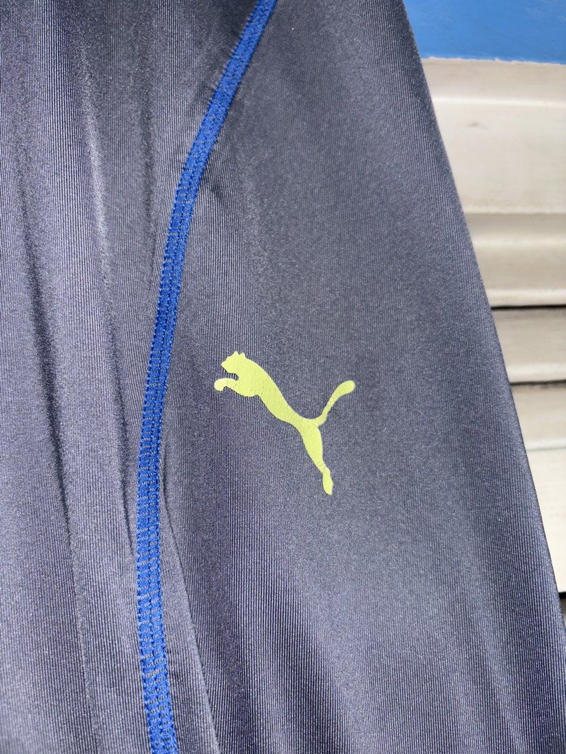 Puma Men's Grey Athletic Tights Size S (Category: Activewear) located in Pasig City. Submitted by timmybatoon (Listing ID 1448076795, Image 3). Description: Puma Compression Tights (GRAY) Size on tag: S (MENS) Dimensions: 27-32inW x 36inL Price: 800 - Grey Puma athletic tights - Blue accents on sides and ankles - Puma logo on left leg - Elastic waistband with Puma branding - Made in Vietnam - Ideal for workouts or running.