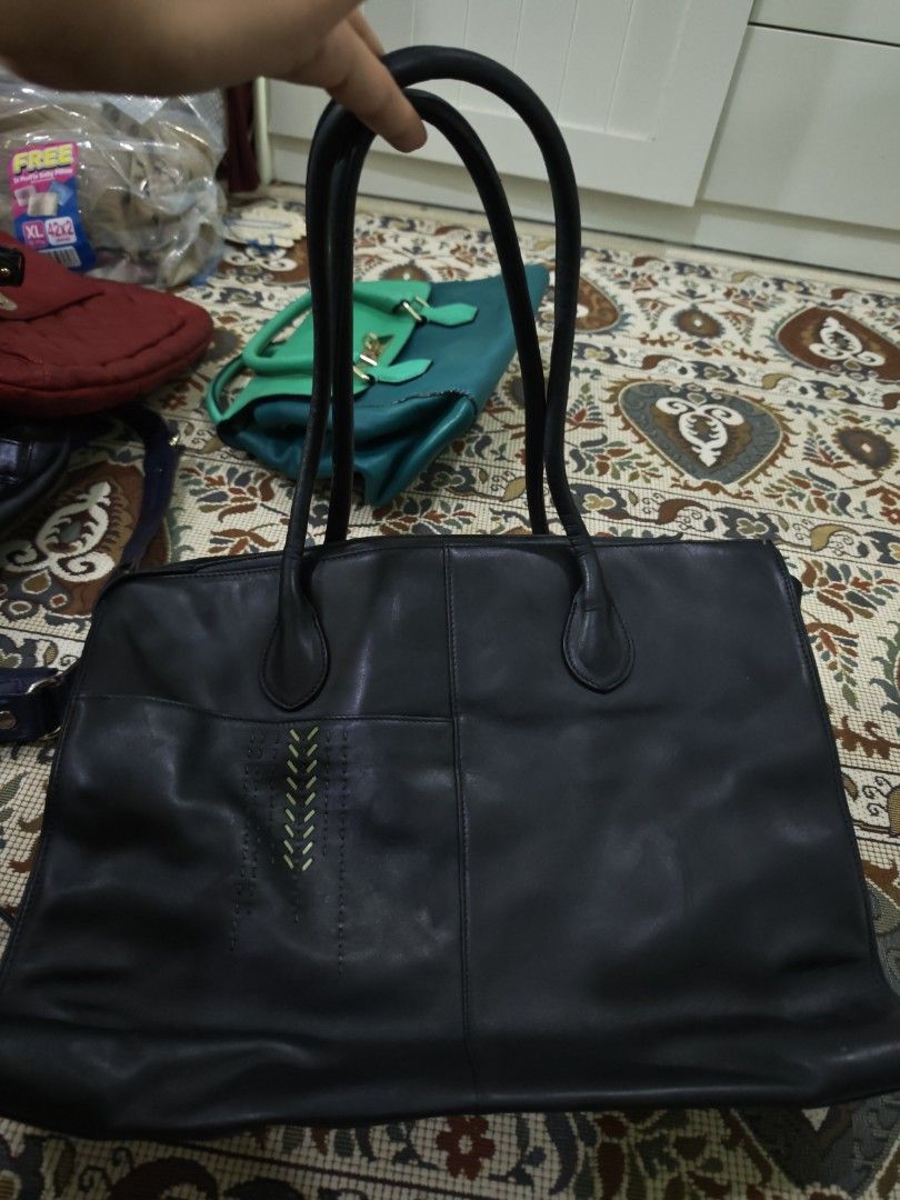 Radley Black Leather Tote Bag (Category: Tote Bags) located in Kulim. Submitted by fortheloveofthrifts (Listing ID 1447969629, Image 1). Description: Black leather tote bag from Radley. Spacious interior with a zip closure. Comfortable shoulder straps. Great for everyday use or work. Plenty of life left in this classic bag. Reference: Laptop is 13in, laptop sleeve 14in. Bag can fit up to 15 or 16in laptop.