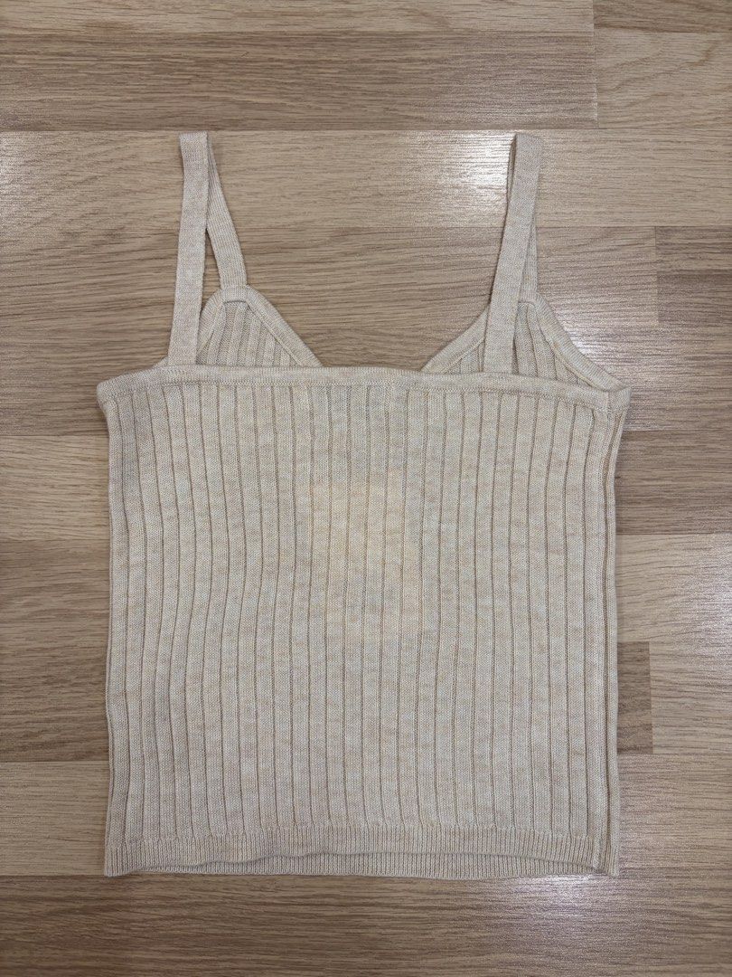 Ribbed Knit Camisole Tank Top (Category: Sleeveless) located in Quezon City. Submitted by leafinds.ph (Listing ID 1447948799, Image 2). Description: - Cream ribbed knit camisole - V-neck with ruched detail - Adjustable spaghetti straps - Estimated size XS/S/M - Soft and stretchy material - Perfect for layering or wearing solo.