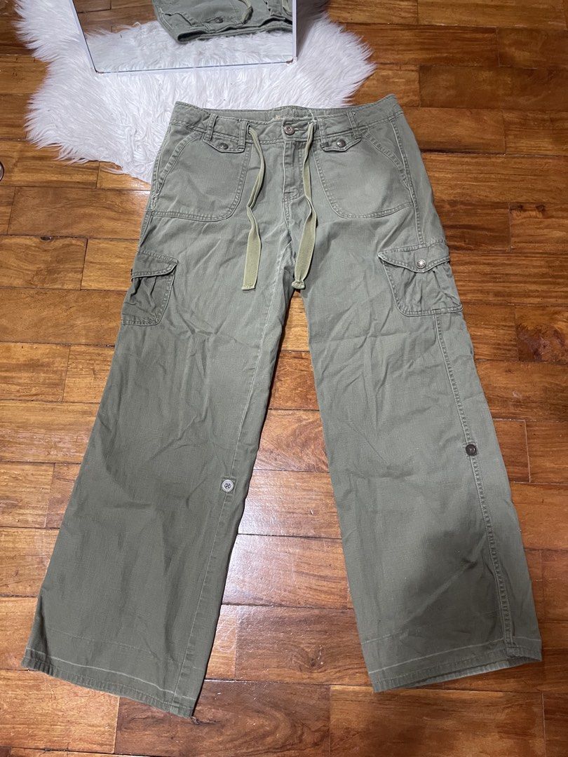 Rika Studios Olive Green Cargo Pants Wide Leg Drawstring (Category: Other Bottoms) located in Cainta. Submitted by FirstBuys (Listing ID 1447994043, Image 1). Description: - Olive green cargo pants from Rika Studios - Features a wide leg design - Adjustable drawstring waist for a comfortable fit - Multiple functional pockets throughout - Unique button closure on the side of the leg - Back pockets also have button closures - Ideal for creating a s