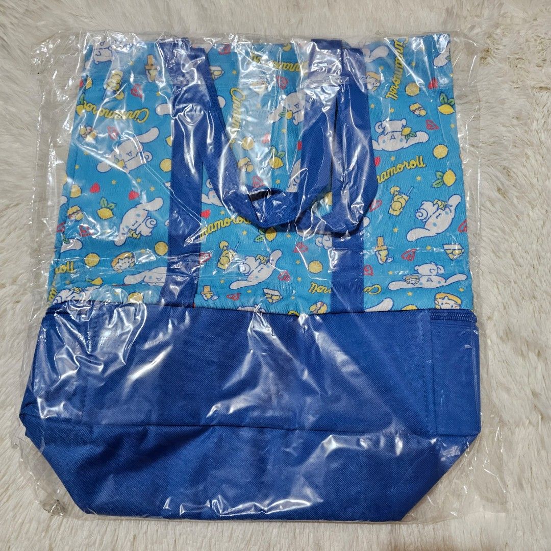 Sanrio Cinnamoroll Blue Tote Bag (Category: Tote Bags) located in Taguig. Submitted by ljdm_22 (Listing ID 1447914821, Image 2). Description: - Adorable Cinnamoroll tote bag - Blue color with a cute all-over Cinnamoroll print - Features a secure zippered at the bottom - Solid blue base for durability - Ideal for grocery runs or everyday errands - Comes in its original packaging, brand new - spacious , with 2 compartments . location : Taguig City 
