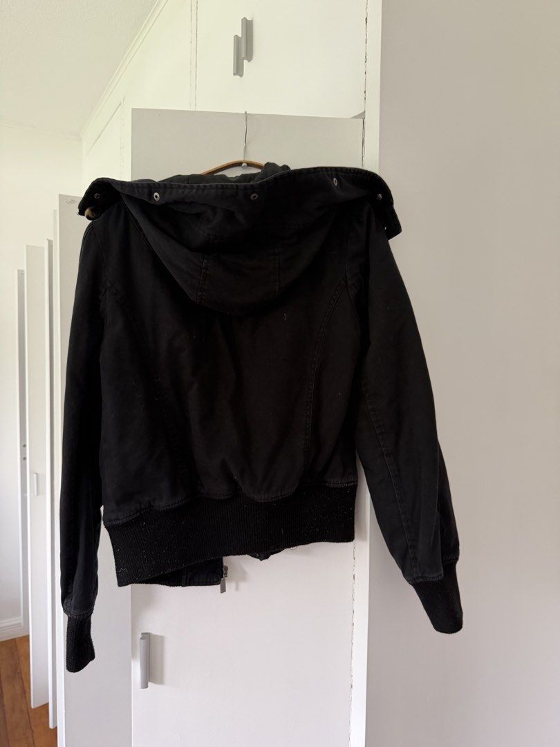 Terranova Black Hooded Bomber Jacket Size M (Category: Coats, Jackets and Outerwear) located in Taguig. Submitted by onein.oneout_declutter (Listing ID 1447896865, Image 3). Description: - Brand: Terranova - Color: Black - Style: Hooded Bomber Jacket - Closure: Button - Interior: Quilted lining - Details: Ribbed cuffs and hem - Size: Medium (M) - Occasion: Casual wear.