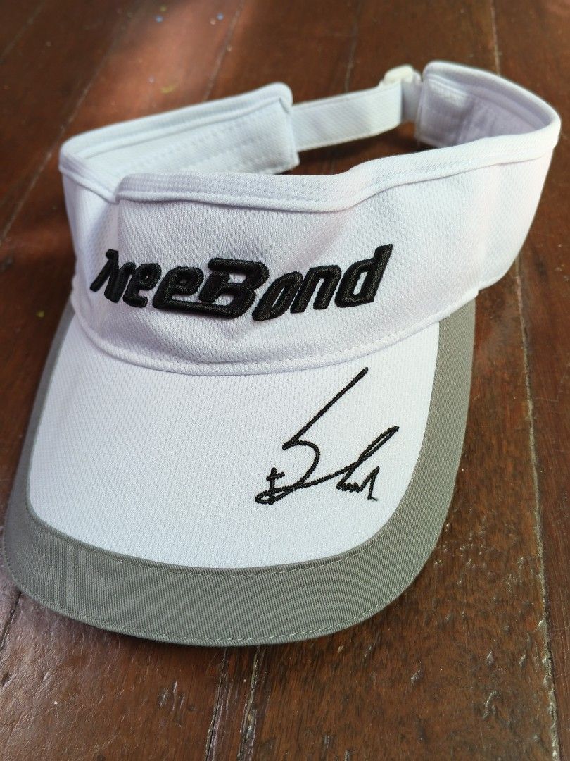 ThreeBond Golf Visor with Autograph (Category: Golf) located in Caloocan City. Submitted by the_good_item05 (Listing ID 1448077048, Image 2). Description: - White and grey golf visor - Embroidered black 'ThreeBond' logo - Black autograph on the brim - Adjustable strap for a comfortable fit - Ideal for sunny days on the golf course.