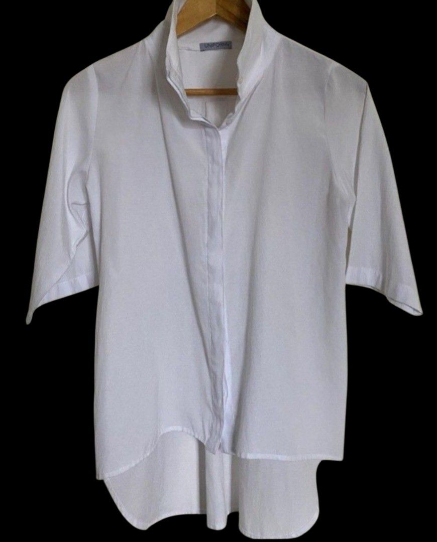 Unif0rm Mavis White Collared Shirt (Category: Shirts) located in Quezon City. Submitted by kcobs (Listing ID 1447944712, Image 1). Description: - Classic white collared shirt by Unif0rm/ Uniform - Unique asymmetrical hemline for a modern look - good condition - Stand-up collar for a chic style - Three-quarter sleeves - Perfect for dressing up or down - white.
