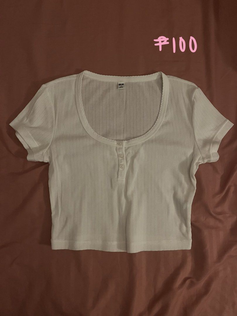 Uniqlo White Ribbed Crop Top (Category: Sleeveless) located in Las Pinas. Submitted by sujninee (Listing ID 1448046235, Image 1). Description: - White ribbed crop top - Henley neckline with button-up front - Short sleeves - Very stretchy material - Best fits size Small to Medium - Ideal for casual wear.