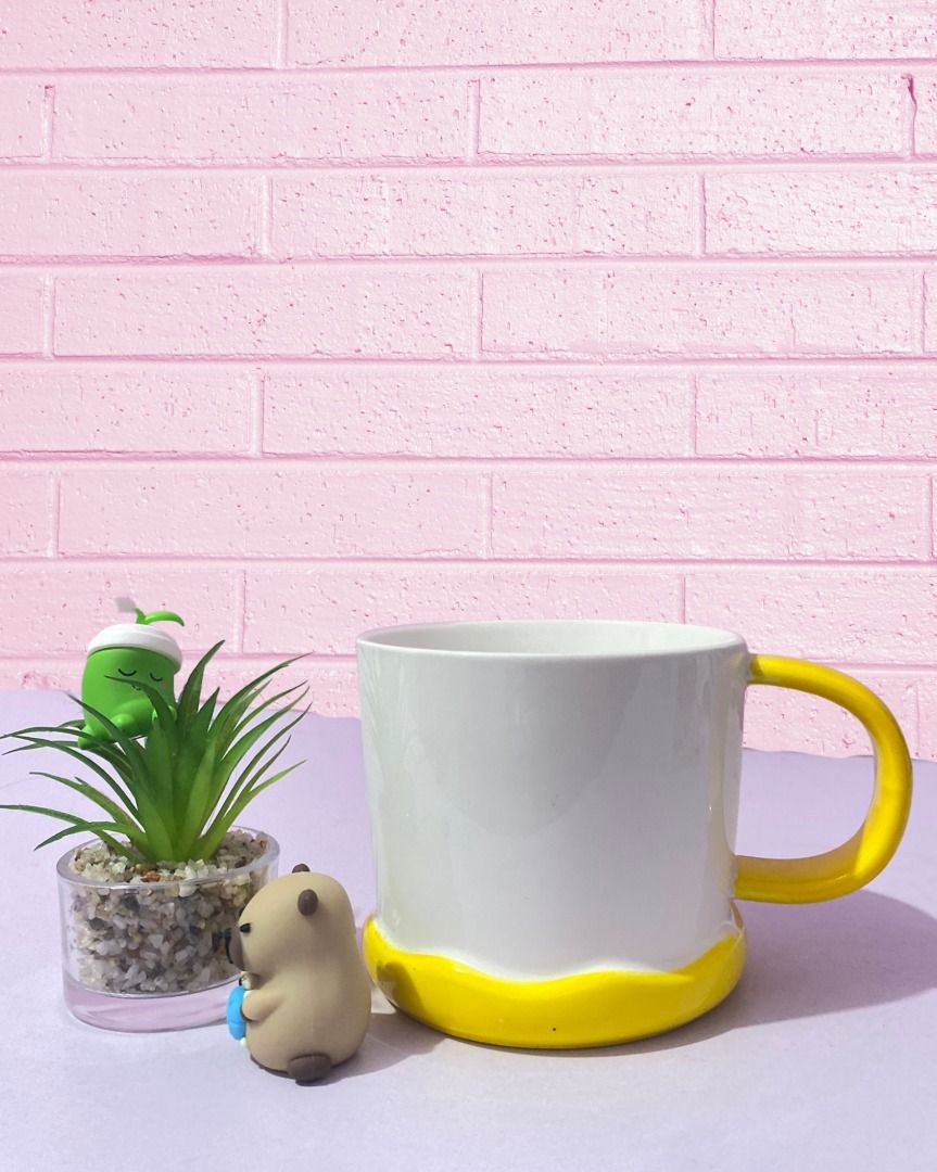 White Ceramic Mug with Yellow Handle and Base (Category: Coffee & Tea Tableware) located in Mandaluyong City. Submitted by pure.ice21 (Listing ID 1447960677, Image 1). Description: 📍 Meet-up Locations: - Mandaluyong City - Batangas City (Alangilan) - Quezon Province (Sariaya) 🚚 Delivery Options: J&T Express Lalamove 💳 Payment Methods: - BPI - GoTyme - MariBank - GCash 📩 Feel free to message me if you have any questions or would like additiona