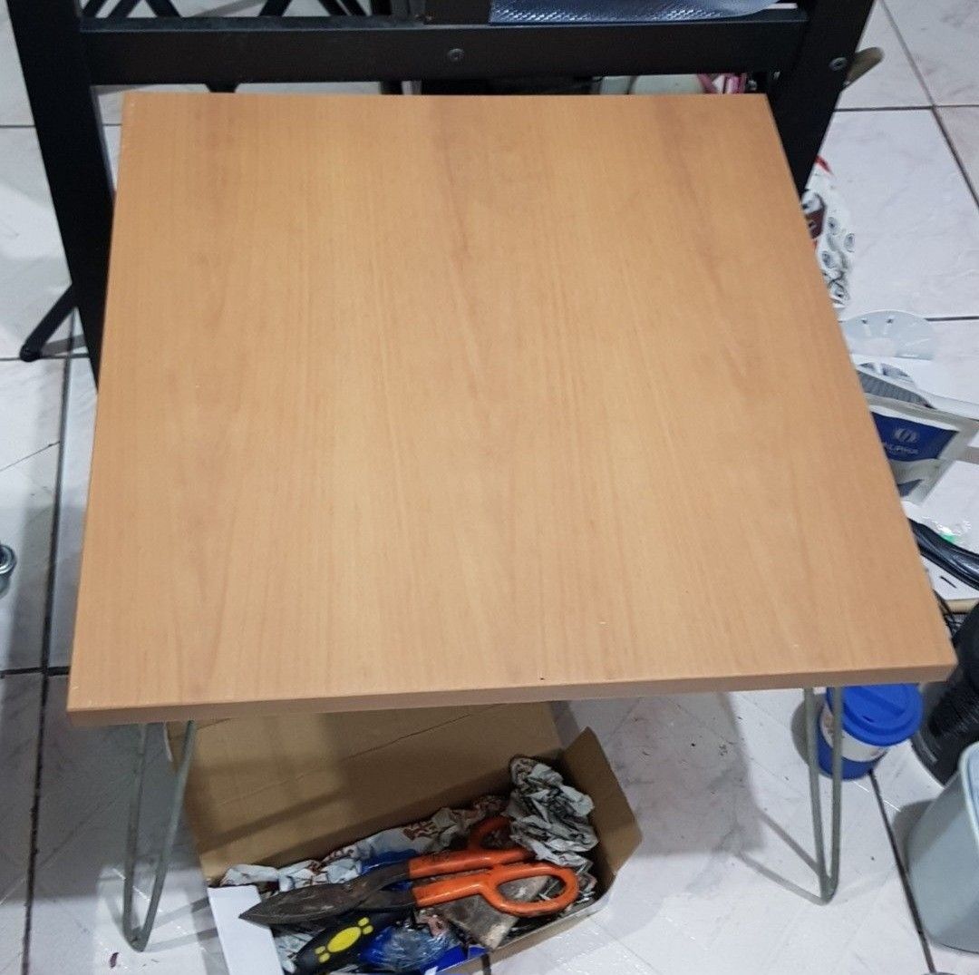 Wooden Folding Table with Metal Legs (Category: Tables & Sets) located in Makati City. Submitted by shopaholicsgallery (Listing ID 1448019342, Image 1). Description: - Compact wooden table with natural light wood grain - Sturdy metal hairpin legs - Perfect for small spaces, as a side table, or for temporary use - Easy to move around - 600cm x 600cm x 450mm.