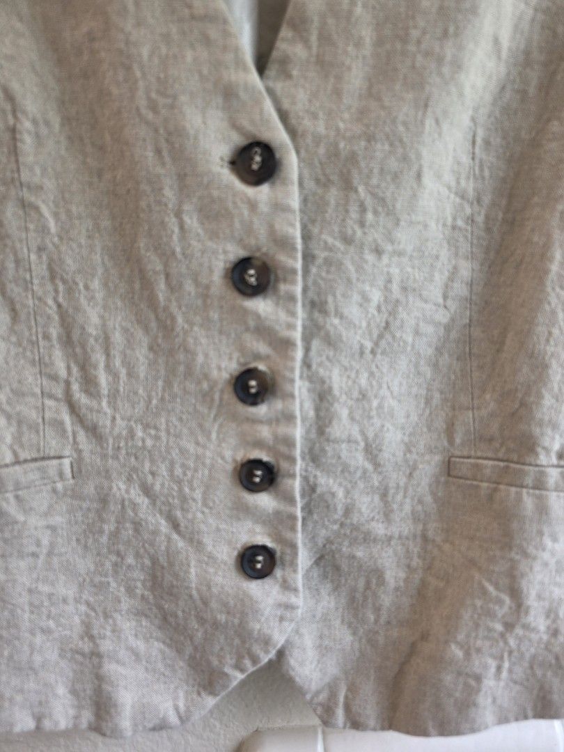 Zara womens Linen Blend Vest medium (Category: Sleeveless) located in Quezon City. Submitted by chinitafrommanila (Listing ID 1448075177, Image 3). Description: - Lightweight linen blend vest from Zara - Button-up front with five buttons - Two functional front pockets - Fully lined interior for a polished look - Versatile neutral color, ideal for layering over shirts or dresses.