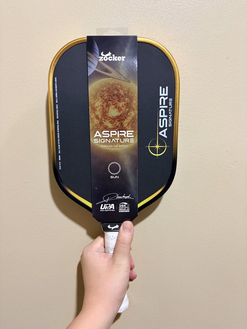 Zocker Aspire Signature (Pickleball Paddle) (Category: Other Sports Equipment and Supplies) located in Manila. Submitted by dinkrpaddlelab (Listing ID 1448043596, Image 2). Description: For Sale Zocker Aspire Signature 👉🏻 Brand New 👉🏻 Onhand 👉🏻 16 mm 👉🏻 Honeycomb Core Available colors: • Neptune (Blue) • Earth (Green) • Sun (Yellow) Comes with: • Free edge tape • Free overgrip Price: ₱9,499 (srp 10k+) For other paddles, check out @dinkrpa