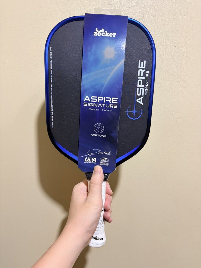Zocker Aspire Signature (Pickleball Paddle) (Category: Other Sports Equipment and Supplies) located in Manila. Submitted by dinkrpaddlelab (Listing ID 1448043596, Image 3). Description: For Sale Zocker Aspire Signature 👉🏻 Brand New 👉🏻 Onhand 👉🏻 16 mm 👉🏻 Honeycomb Core Available colors: • Neptune (Blue) • Earth (Green) • Sun (Yellow) Comes with: • Free edge tape • Free overgrip Price: ₱9,499 (srp 10k+) For other paddles, check out @dinkrpa
