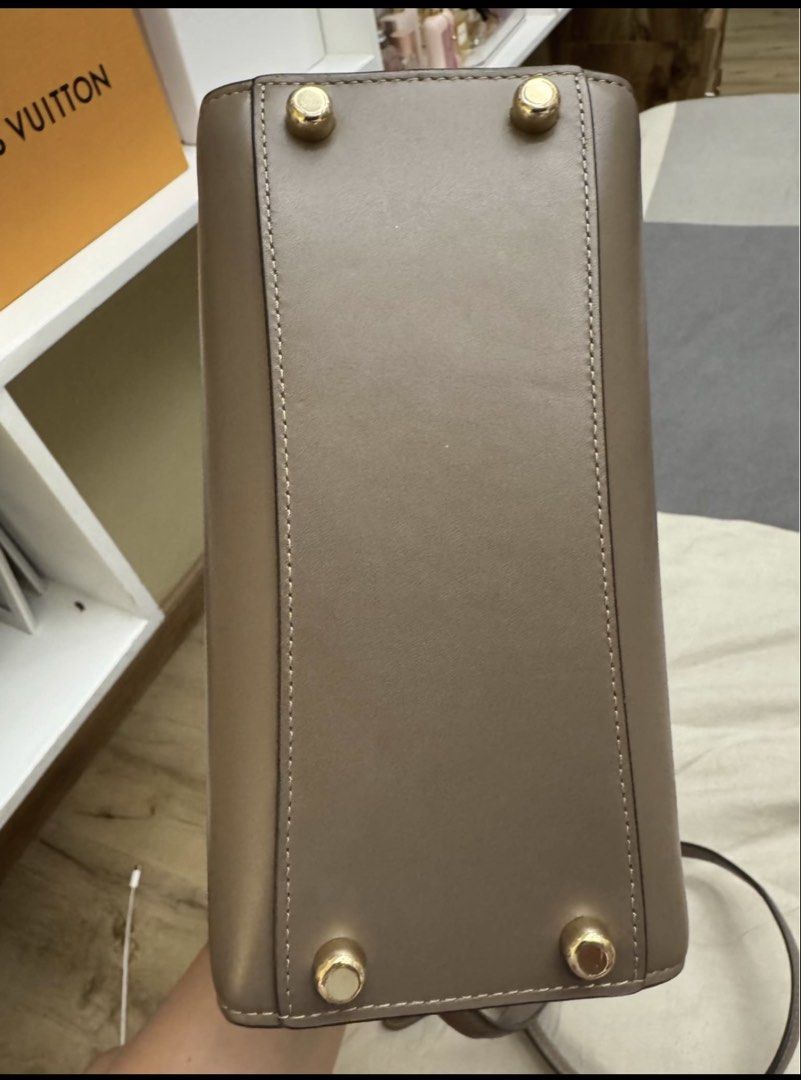 Authentic Coach mini Andrea Bag in chocolate color (Category: Luxury Bags & Wallets) located in Alaminos. Submitted by wearme_imnice (Listing ID 1448086197, Image 3). Description: - Genuine Coach top handle bag in taupe. - Made from authentic leather. - Features elegant gold hardware details. - Comes with a detachable shoulder strap for versatile carrying. - Includes a small, matching leather tag. - Interior is clean and well-maintained. - Ideal 