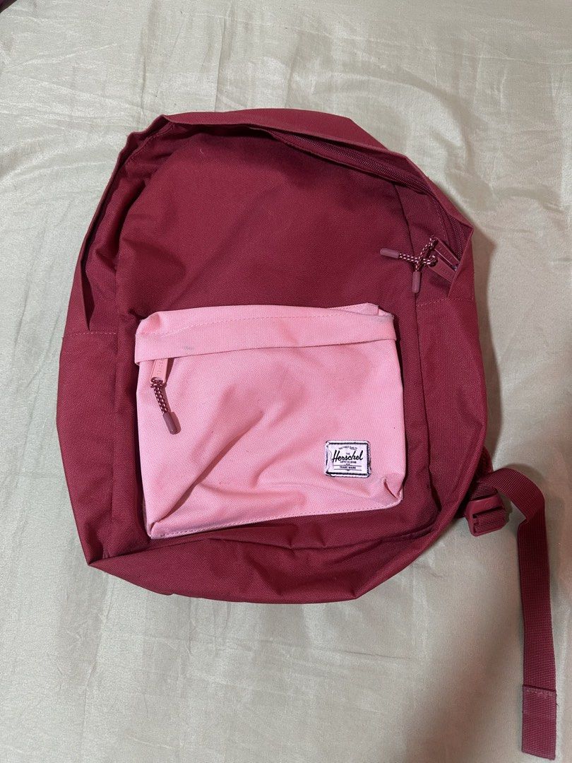 Authentic Herschel Backpack - Red with Pink Front Pocket (Category: Backpacks) located in Taguig. Submitted by sassythrifter (Listing ID 1448148180, Image 1). Description: - Authentic Herschel backpack - Color: Deep Red with a contrasting Pink front pocket - Features the iconic Herschel striped interior lining - Classic and durable design - Front pocket with zipper for easy access - Suitable for everyday use and travel - Condition: Excellent, wel
