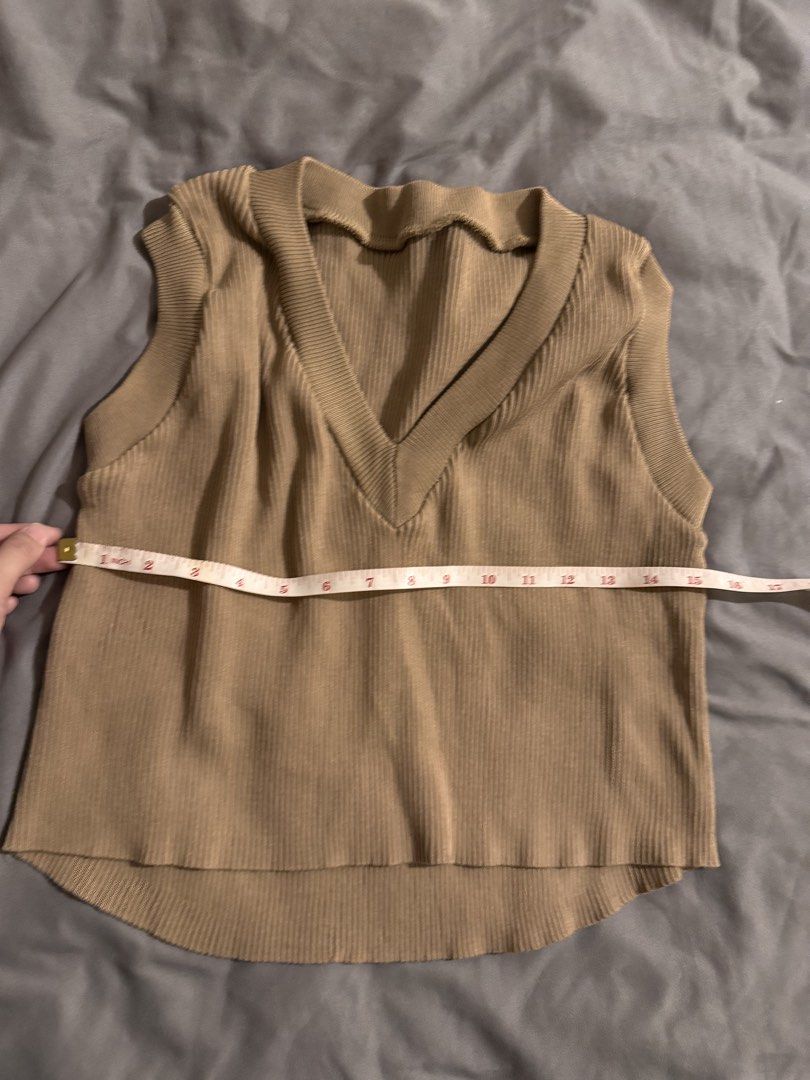 Beige V-neck Sleeveless Knit Top (Category: Sleeveless) located in Quezon City. Submitted by ianne.declutter (Listing ID 1447065556, Image 2). Description: RFS: impulse buy of other colors color beige doesnt suit me CONDITION: once used only - Casual beige knit top - V-neckline with ribbed texture - Sleeveless design - Versatile for layering or wearing alone - Comfortable for everyday wear - Pairs well with trousers or skirts.