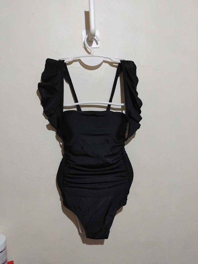 Black One-Piece Swimsuit with Ruffle Sleeves (Category: Bikinis & Swimsuits) located in Manila. Submitted by purplethings28 (Listing ID 1448238057, Image 1). Description: - Cute black one-piece swimsuit - Ruffled sleeves for a feminine touch - Flattering side ruching design - Stylish strappy back detail - Ideal for beach days or pool lounging - Get ready for your next vacation! large on tag but fit to small to semi large only brandnew... orig pri