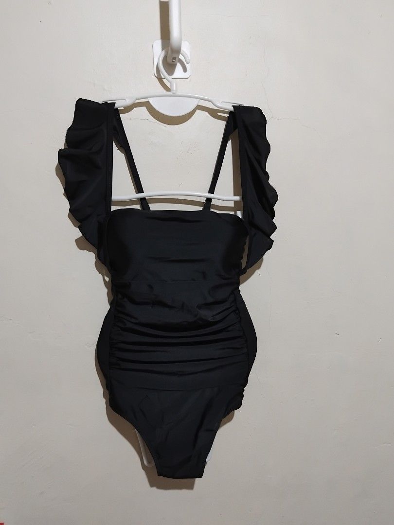 Black One-Piece Swimsuit with Ruffle Sleeves (Category: Bikinis & Swimsuits) located in Manila. Submitted by purplethings28 (Listing ID 1448238057, Image 3). Description: - Cute black one-piece swimsuit - Ruffled sleeves for a feminine touch - Flattering side ruching design - Stylish strappy back detail - Ideal for beach days or pool lounging - Get ready for your next vacation! large on tag but fit to small to semi large only brandnew... orig pri
