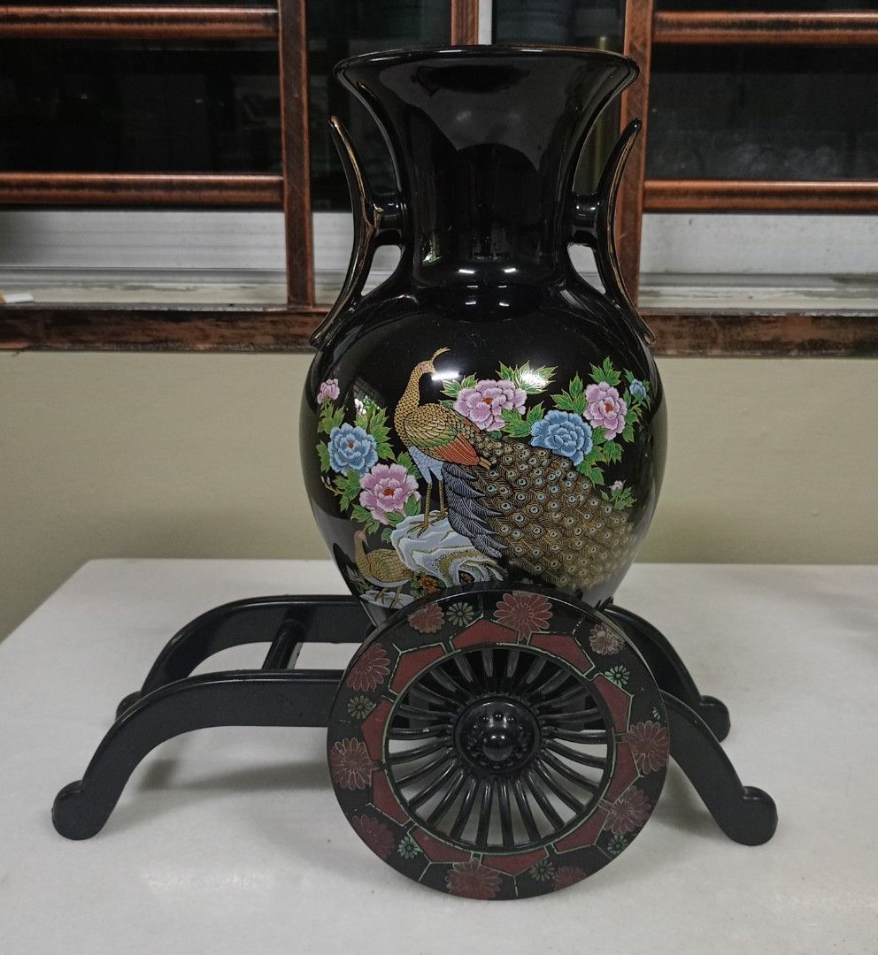 Black Peacock Vase with Decorative Stand (Category: Vases & Decorative Bowls) located in Johor Bahru. Submitted by swong777 (Listing ID 1448105075, Image 1). Description: - Elegant black vase featuring a stunning peacock and floral design. - Comes with a unique decorative stand equipped with wheels for easy placement. - Ideal for enhancing your home decor and adding a vibrant pop of color. - Versatile use: perfect for showcasing fresh flowers or 