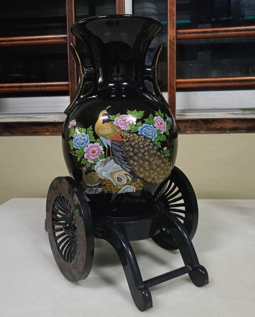 Black Peacock Vase with Decorative Stand (Category: Vases & Decorative Bowls) located in Johor Bahru. Submitted by swong777 (Listing ID 1448105075, Image 2). Description: - Elegant black vase featuring a stunning peacock and floral design. - Comes with a unique decorative stand equipped with wheels for easy placement. - Ideal for enhancing your home decor and adding a vibrant pop of color. - Versatile use: perfect for showcasing fresh flowers or 