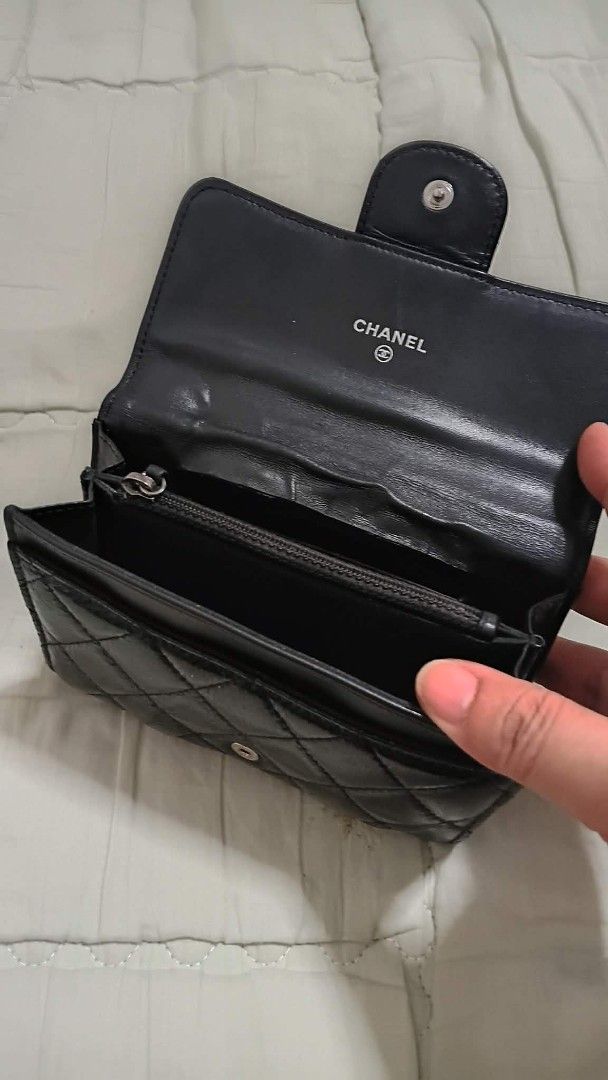 Chanel Black Patent Quilted Wallet (Category: Luxury Bags & Wallets) located in Manila. Submitted by melsalgado42455 (Listing ID 1448183348, Image 3). Description: - Black Patent Leather Chanel Wallet - Classic Quilted Design - Iconic CC Logo - Interior: Card Slots & Zip Pocket - Made in Italy - Shows some signs of wear on edges and interior.