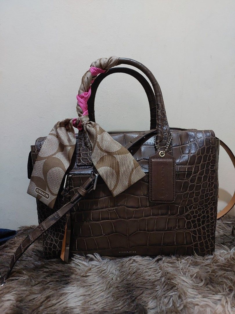 Coach Brown Croc Embossed Leather Satchel Handbag (Category: Luxury Bags & Wallets) located in Malabon City. Submitted by jullie_bag_shop (Listing ID 1448227009, Image 1). Description: - Authentic Brown Coach Satchel Bag - Luxurious Croc-Embossed Leather - Top Handles with Decorative Scarf - Secure Zipper Closure - Multiple Interior Pockets for Organization - Comes with Original Coach Hangtag - Ideal Everyday Bag.