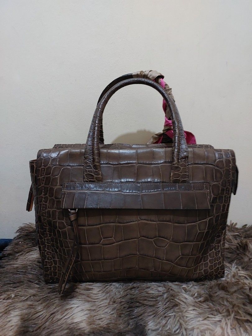 Coach Brown Croc Embossed Leather Satchel Handbag (Category: Luxury Bags & Wallets) located in Malabon City. Submitted by jullie_bag_shop (Listing ID 1448227009, Image 3). Description: - Authentic Brown Coach Satchel Bag - Luxurious Croc-Embossed Leather - Top Handles with Decorative Scarf - Secure Zipper Closure - Multiple Interior Pockets for Organization - Comes with Original Coach Hangtag - Ideal Everyday Bag.