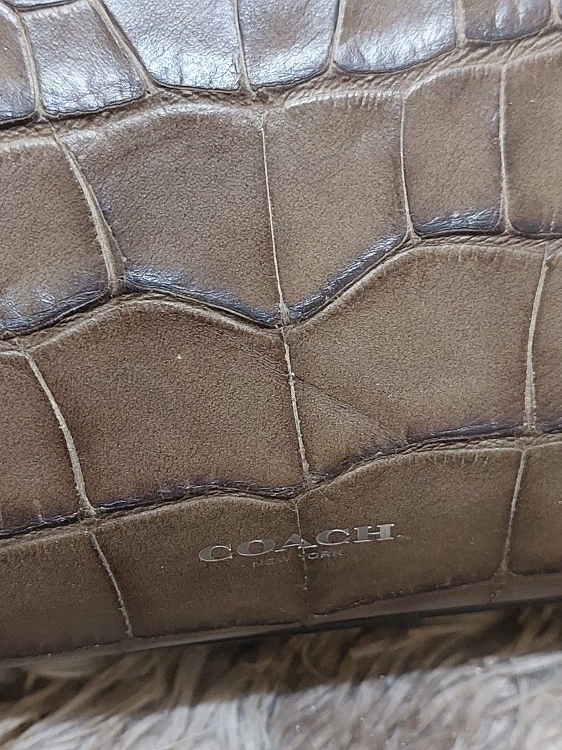 Coach Brown Croc Embossed Leather Satchel Handbag (Category: Luxury Bags & Wallets) located in Malabon City. Submitted by jullie_bag_shop (Listing ID 1448227009, Image 2). Description: - Authentic Brown Coach Satchel Bag - Luxurious Croc-Embossed Leather - Top Handles with Decorative Scarf - Secure Zipper Closure - Multiple Interior Pockets for Organization - Comes with Original Coach Hangtag - Ideal Everyday Bag.