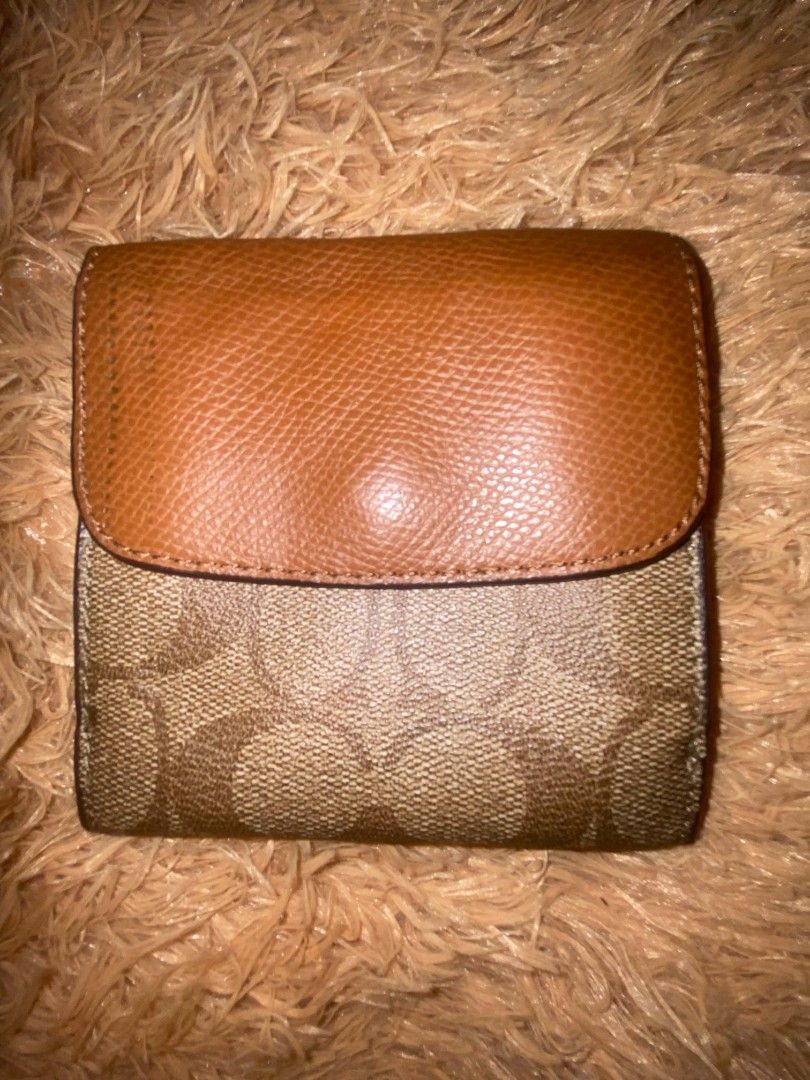 Coach Monogram Trifold Wallet Brown Leather (Category: Wallets & Card holders) located in Zamboanga. Submitted by nurjimdigo71795 (Listing ID 1448205159, Image 2). Description: - Coach trifold wallet in brown signature monogram canvas - Genuine leather trim - Ample card slots for organization - Secure snap closure - Shows some signs of wear on interior leather and edges - Still has plenty of life left, a timeless Coach accessory.