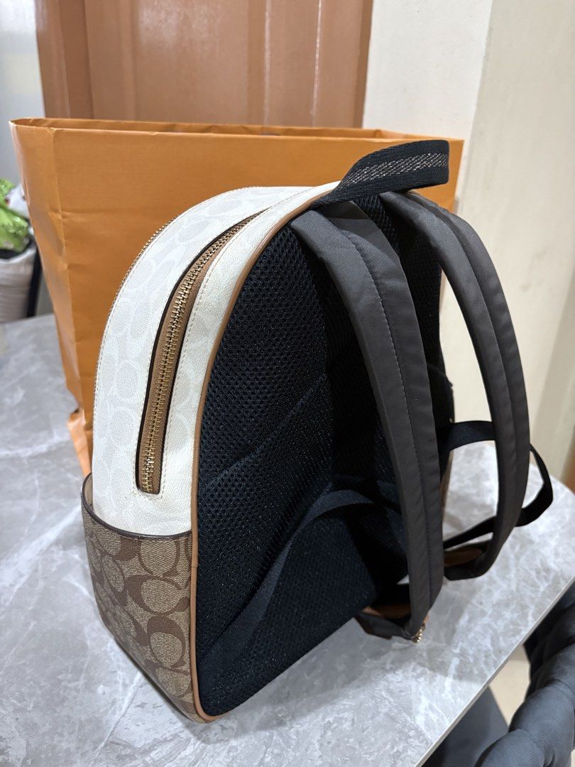 Coach Signature Monogram Backpack White Brown (Category: Luxury Bags & Wallets) located in Pasay City. Submitted by shienlee (Listing ID 1448212590, Image 3). Description: - Authentic Coach backpack - Signature monogram print - Classic white and brown colorway - Convenient front zip pocket - Spacious main compartment - Adjustable straps for a comfortable fit - Ideal for everyday errands or travel adventures.