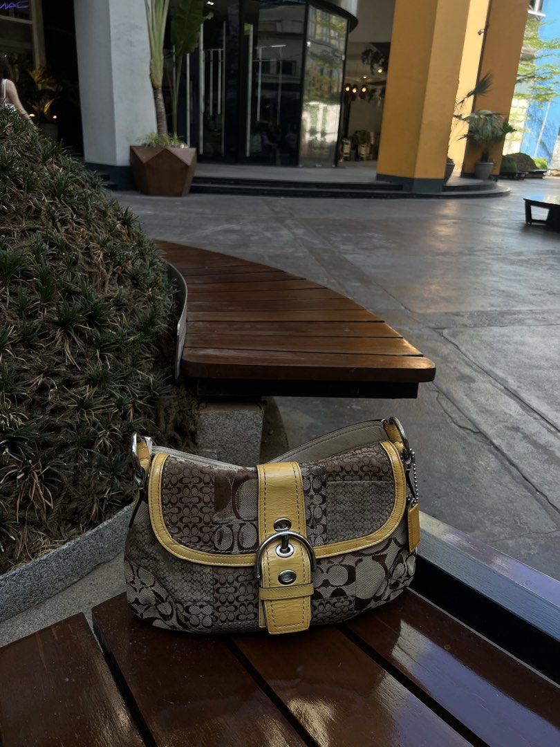 Coach Signature Monogram Shoulder Bag (Category: Luxury Bags & Wallets) located in Taytay. Submitted by zdeclut (Listing ID 1448140973, Image 2). Description: - Classic Coach shoulder bag - Signature monogram pattern - Tan leather accents - Front flap with buckle detail - Spacious interior for essentials - Ideal for everyday use Sign of vintage Please check photos, wrinkly shoulder strap but all in tack. Cleaned .