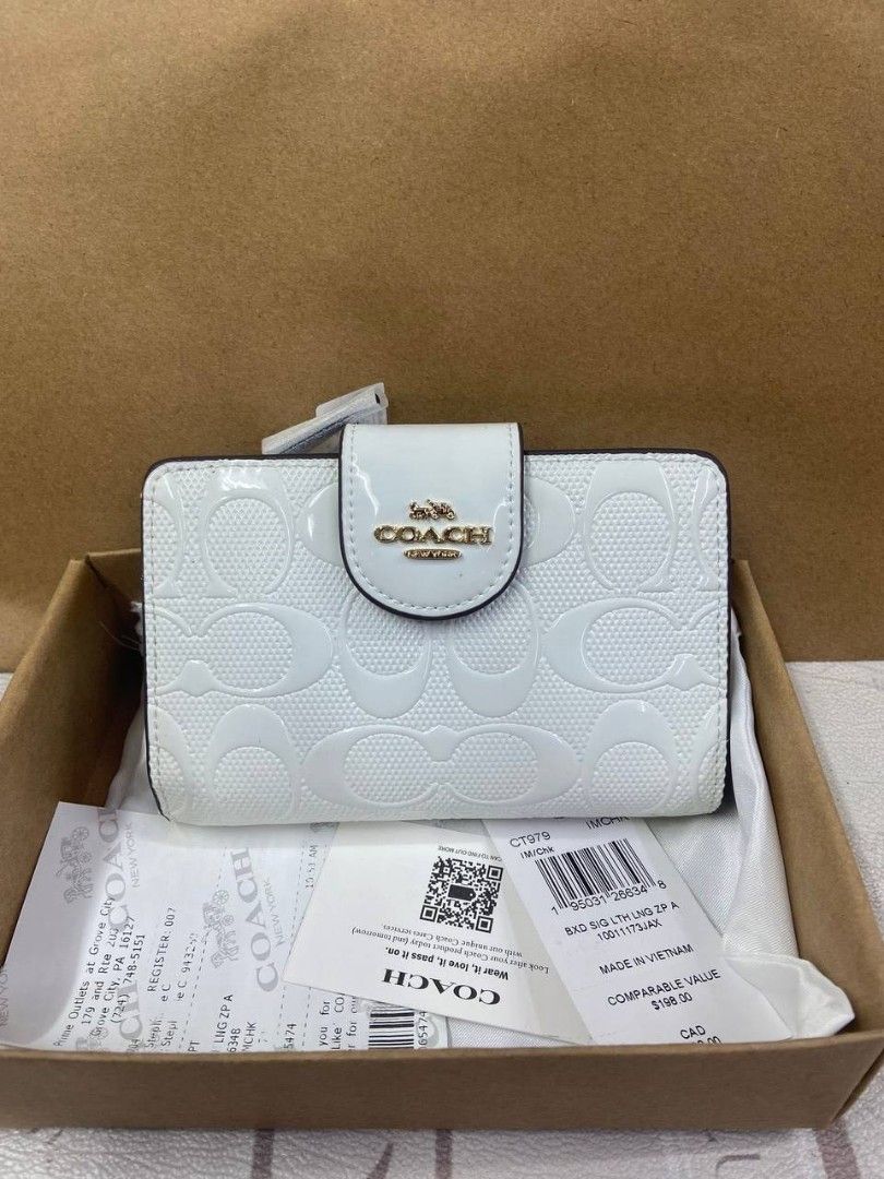 Coach Snap Wallet In Signature Canvas (Category: Purses & Pouches) located in Manila. Submitted by theluxecornerph (Listing ID 1448229024, Image 3). Description: - Coach Snap Wallet - Signature C print - Available Colors: Pink, Multi-color, White, Floral Print, Brown - Includes Original Tags and Box - Made in Vietnam - Ideal Gift Idea.