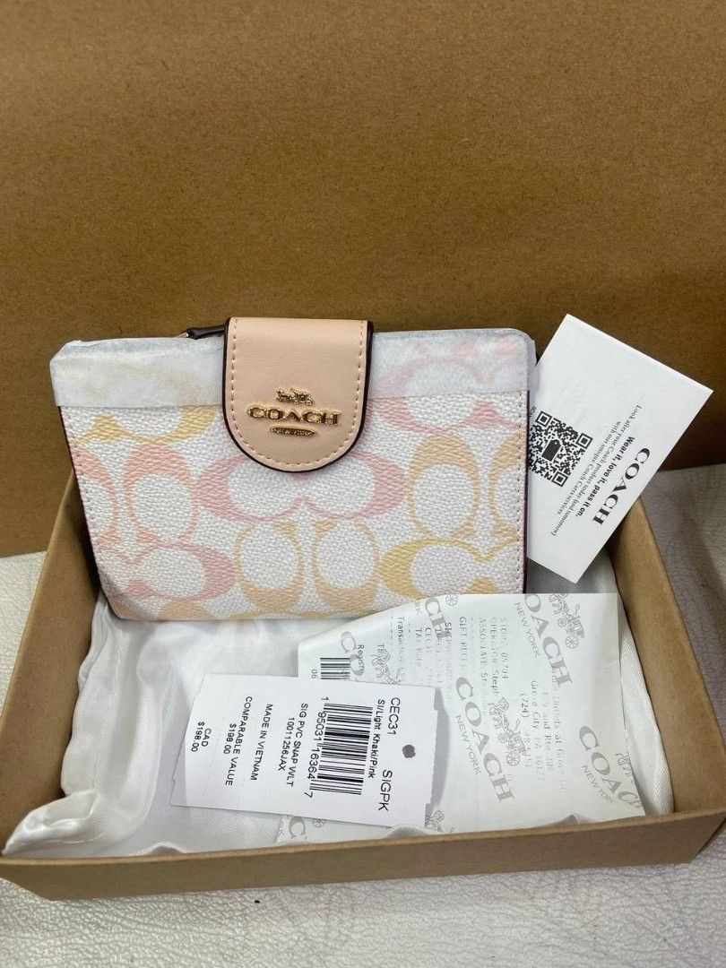 Coach Snap Wallet In Signature Canvas (Category: Purses & Pouches) located in Manila. Submitted by theluxecornerph (Listing ID 1448229024, Image 2). Description: - Coach Snap Wallet - Signature C print - Available Colors: Pink, Multi-color, White, Floral Print, Brown - Includes Original Tags and Box - Made in Vietnam - Ideal Gift Idea.