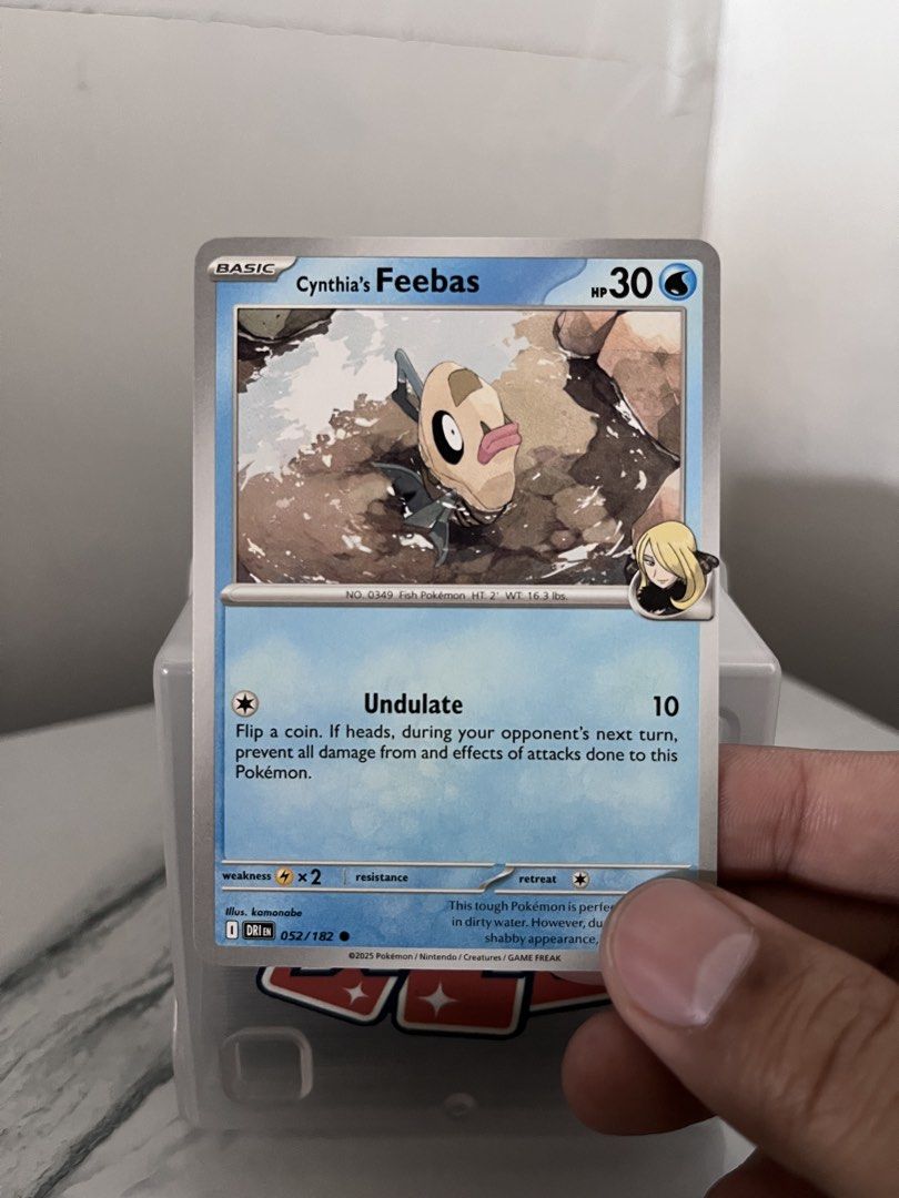 Cynthia's Feebas Pokemon Card 052/182 (Category: Raw Singles) located in Pasay City. Submitted by paullimerized (Listing ID 1448184494, Image 1). Description: - Cynthia's Feebas Pokemon Card - Year: 2021 - Card Type: Basic - HP: 30 - Attack: Undulate - Ideal for Pokemon TCG collectors.