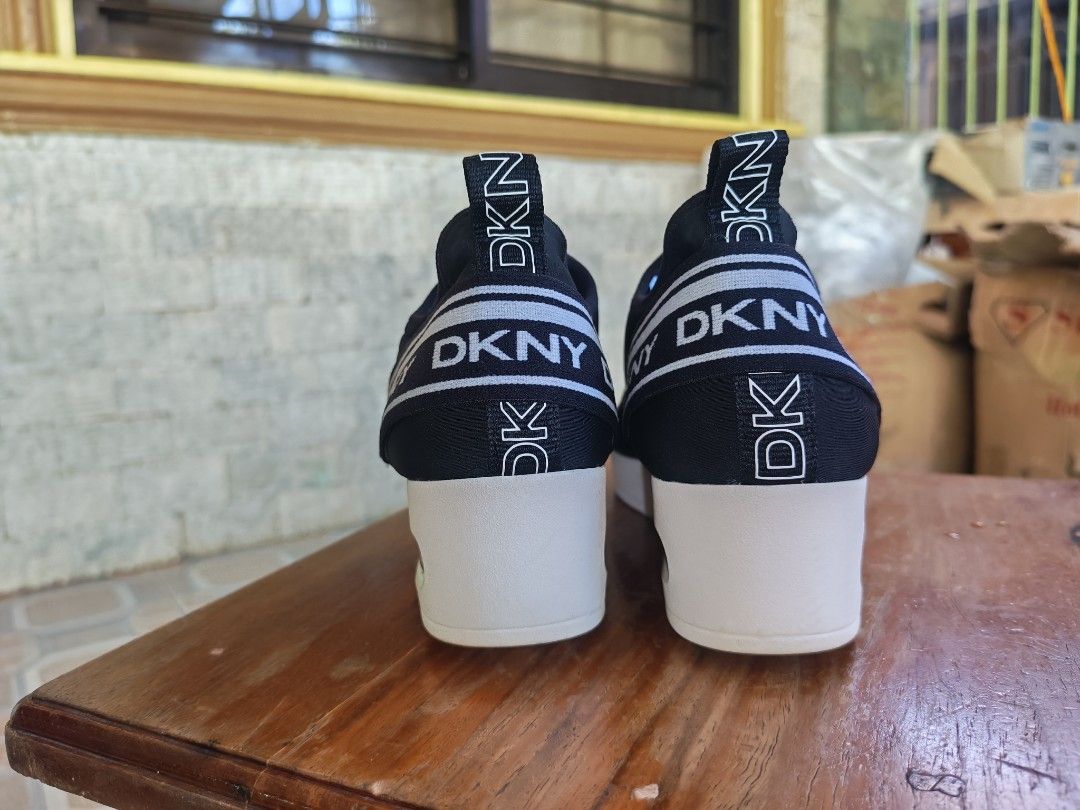 DKNY Black Slip-On Wedge Sneakers (Category: Sneakers) located in Caloocan City. Submitted by erickastella02 (Listing ID 1448137645, Image 3). Description: - Black DKNY slip-on sneakers - Size: 9.5US - EUR 40.5 - Features DKNY logo tape around wedge heel and on shoe - Cushioned sole with clear air bubble detail - Easy slip-on style.