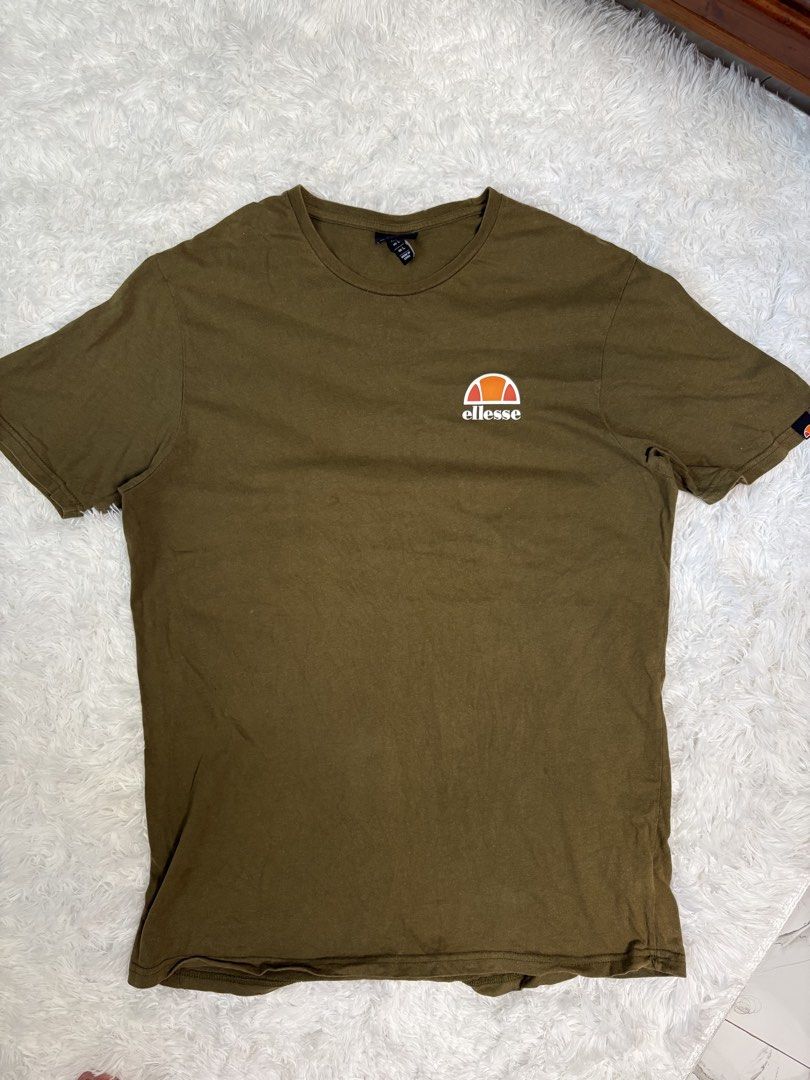Ellesse T-Shirt Size L (Olive Green) (Category: Tshirts & Polo Shirts ) located in Caloocan City. Submitted by saturday.archives1 (Listing ID 1448217847, Image 1). Description: - Classic olive green Ellesse t-shirt - Features iconic Ellesse logo on chest - Simple crew neck, short sleeves - Size L - Great for casual wear - Please check photos for condition details.