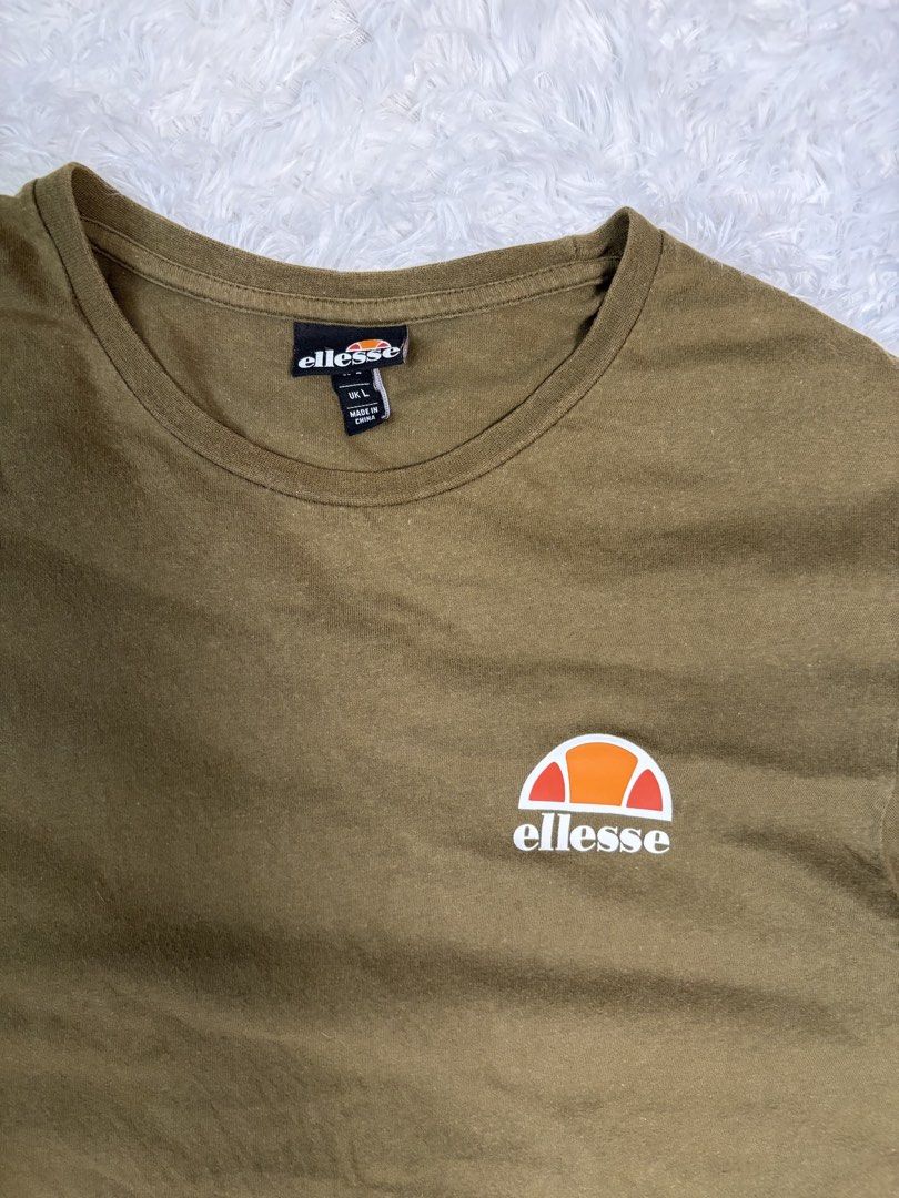 Ellesse T-Shirt Size L (Olive Green) (Category: Tshirts & Polo Shirts ) located in Caloocan City. Submitted by saturday.archives1 (Listing ID 1448217847, Image 2). Description: - Classic olive green Ellesse t-shirt - Features iconic Ellesse logo on chest - Simple crew neck, short sleeves - Size L - Great for casual wear - Please check photos for condition details.