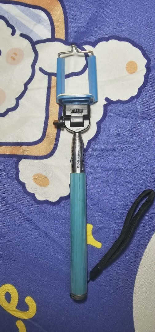 Extendable Selfie Stick with Phone Holder (Category: Tripods & Monopods) located in Manila. Submitted by mwnadala (Listing ID 1448173181, Image 2). Description: Condition: Used Reason for Selling: No more need Meet Up Location: LRT 2 V Mapa Station, Amaia Skies V. Mapa, Kalentong Market, Our Lady of Lourdes Hospital, Bacood Elementary School or nearby areas Issues: None Features: - Extendable selfie stick in stylish teal and blue. - Adjustable ph