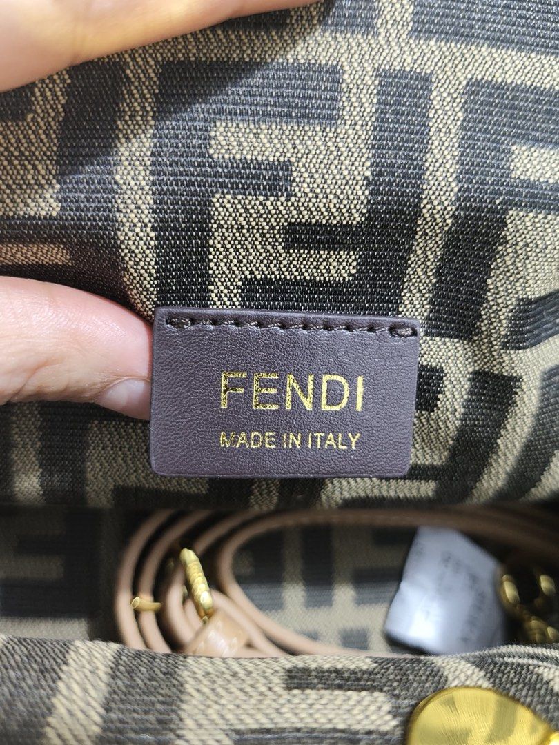 Fendi Baguette Bag (Category: Luxury Bags & Wallets) located in Cebu City. Submitted by latendacebubuys (Listing ID 1448198951, Image 3). Description: - Fendi bag - Classic FF monogram canvas - Tan leather trim - Gold hardware - Detachable strap included - Made in Italy - Versatile for day or night use.