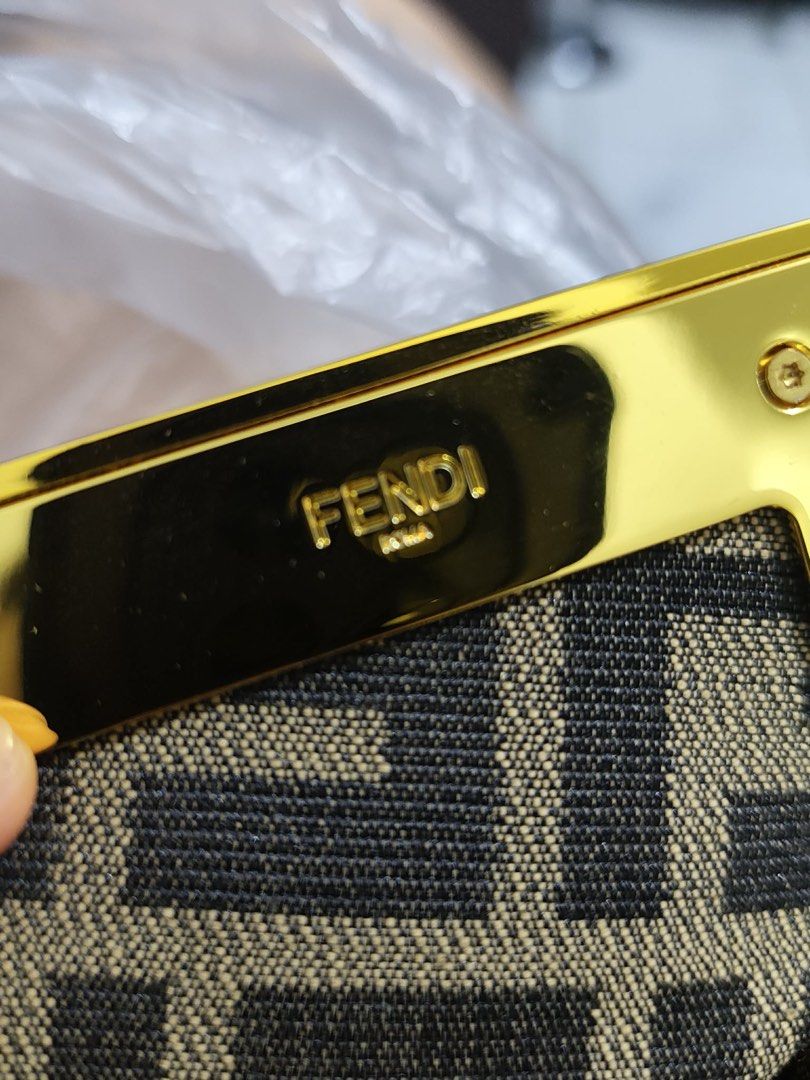 Fendi Baguette Bag (Category: Luxury Bags & Wallets) located in Cebu City. Submitted by latendacebubuys (Listing ID 1448198951, Image 2). Description: - Fendi bag - Classic FF monogram canvas - Tan leather trim - Gold hardware - Detachable strap included - Made in Italy - Versatile for day or night use.