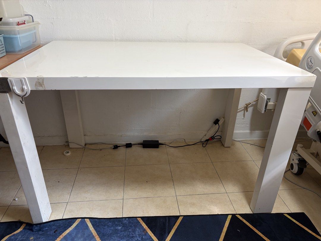 FOC White Rectangular Table (Category: Tables & Sets) located in Singapore. Submitted by freesoul (Listing ID 1448147910, Image 1). Description: - White table, ideal for study or work - Sturdy construction with reliable legs - Dimensions: Approximately 120cm x 75cm x 75cm - Surface is generally clean - Please note: Some wear and tear on edges and corners, as pictured, easily covered by table cloth. .