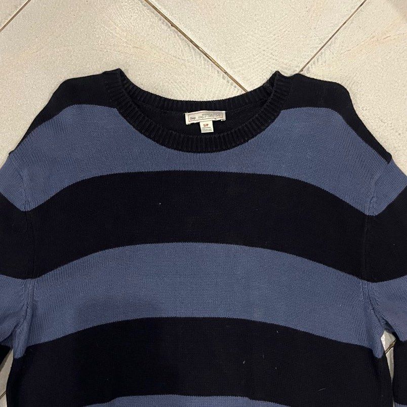 Gap Striped Crewneck Sweater (Category: Longsleeves) located in Santa Rosa. Submitted by bats_ (Listing ID 1448228631, Image 3). Description: - Classic blue and black stripes - Brand: Gap - Style: Long sleeve, crewneck sweater - Material: Soft knit fabric - Versatile: Great for layering or wearing solo - Easy to style with jeans or trousers.