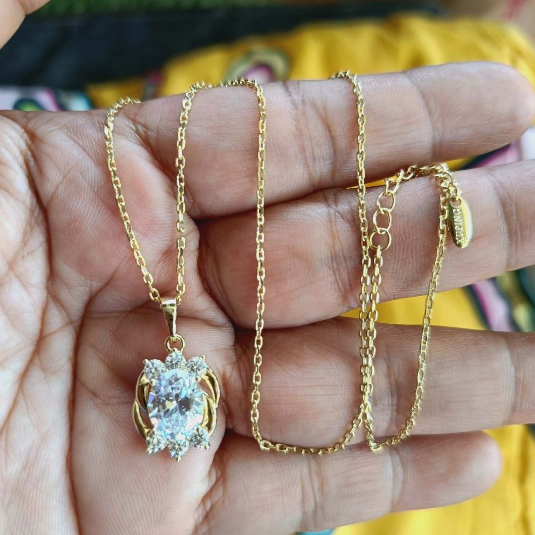 Gold Chain Necklace with Snowflake Pendant (Category: Necklaces) located in Cagayan de Oro. Submitted by mmmdshop (Listing ID 1448176198, Image 3). Description: - Delicate gold chain necklace, approximately 18 inches long. - Features a sparkly snowflake pendant encrusted with clear stones. - Secure lobster clasp closure. - Adds a beautiful sparkle to any outfit. - Ideal for gifting or personal treat..