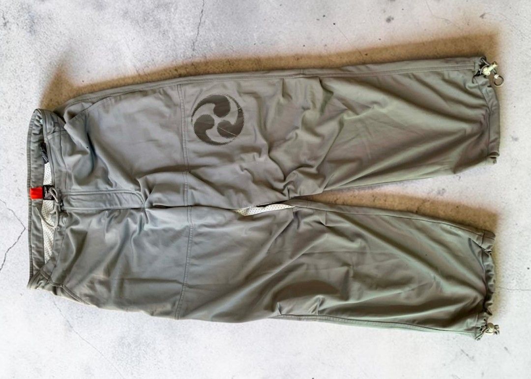 Grey Cargo Pants with Japanese Symbol (Category: Jeans) located in Mangaldan. Submitted by michelle_2004 (Listing ID 1448135020, Image 1). Description: - Grey cargo pants - Drawstring waist - Adjustable ankle cuffs - Unique Japanese symbol graphic on left thigh - Made of 100% polyester - Ideal for casual wear or outdoor activities.