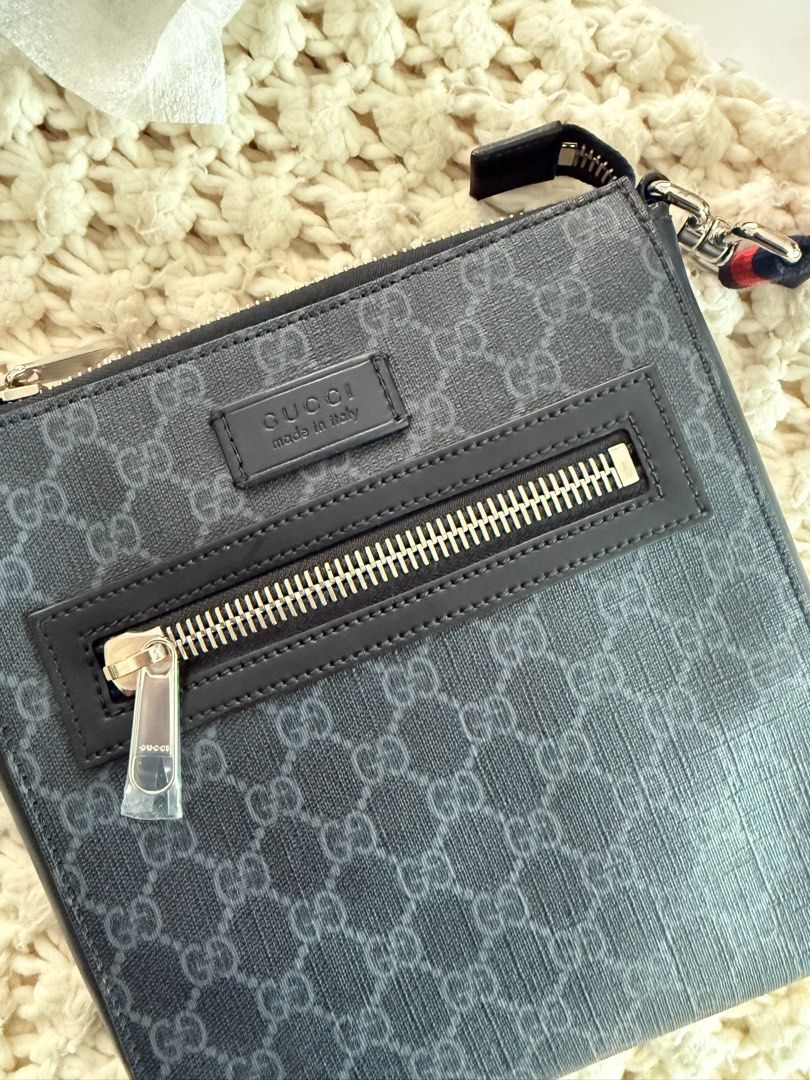 Gucci GG Supreme Monogram Crossbody Bag (Category: Luxury Bags & Wallets) located in Cebu City. Submitted by sararanile (Listing ID 1448086111, Image 2). Description: Authentic Gucci GG Supreme crossbody bag in black and grey. Features a front zip pocket and adjustable red/blue stripe strap. Made in Italy. Includes dust bag. 100% authentic .