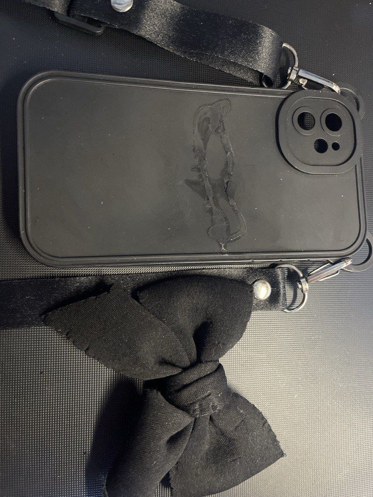 iPhone 11 Case Black with Ribbon and Strap (Category: Cases & Sleeves) located in Manila. Submitted by rosetteliab (Listing ID 1448248301, Image 1). Description: Ribbon was detached from the case, can be attached using mighty bond. Strap is still functional..