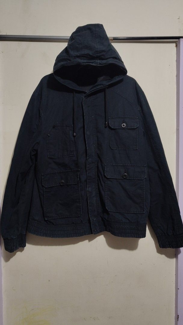 Jack & Jones Dark Blue Hooded Utility Jacket (Category: Coats, Jackets and Outerwear) located in Bulacan. Submitted by adrian2325 (Listing ID 1448099061, Image 1). Description: - Dark blue Jack & Jones jacket - Features a hood - Multiple front pockets - Zip and button closure - Ribbed hem and cuffs - Perfect for casual wear - Estimated size L or XL (check measurements if needed).
